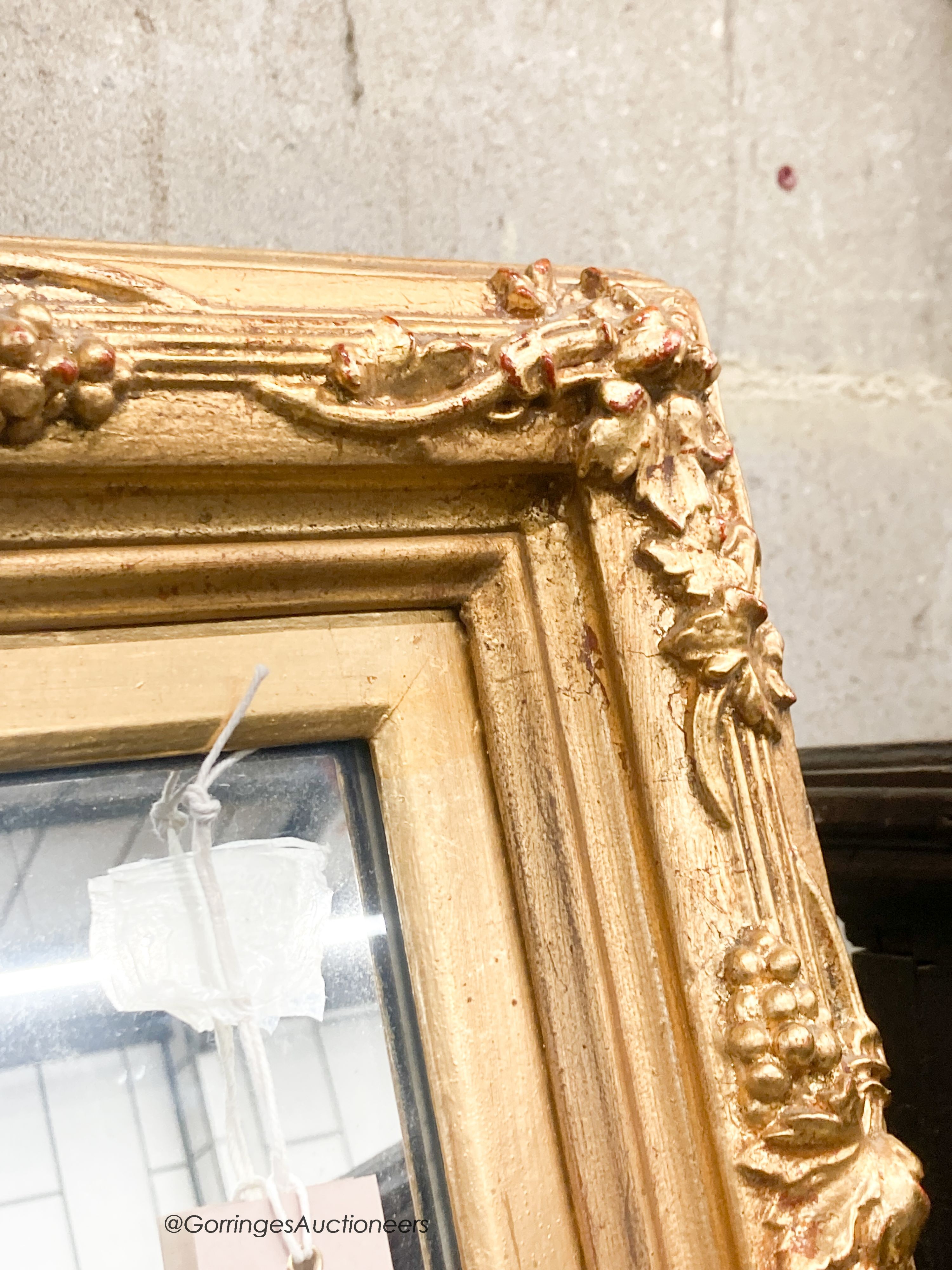 A rectangular carved giltwood framed wall mirror, width 67cm, height 132cm